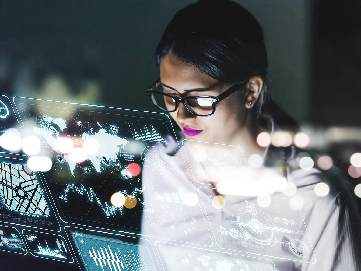 Woman working on data and analytics consulting using virtual interfaces.