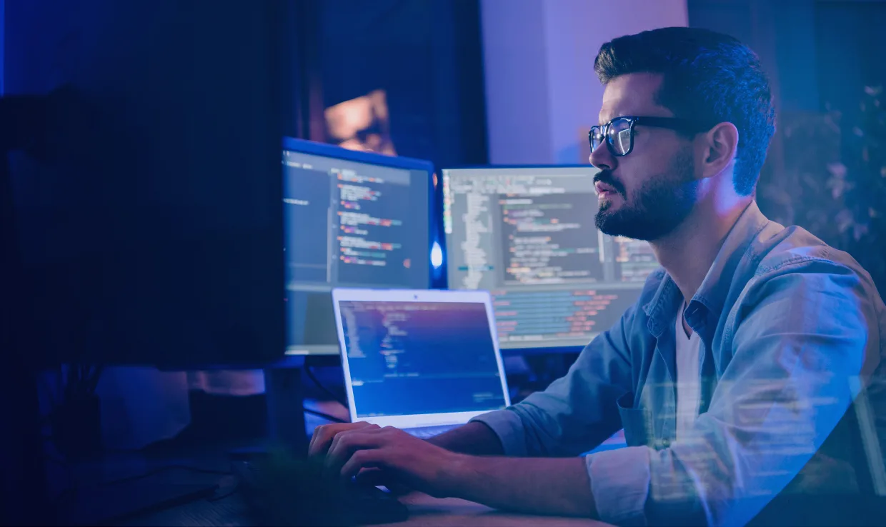 Man using multiple computers for big data processing.